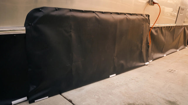 EZ Snap solid skirting panel snapped along its top hem, with ground rails sealing the bottom edge to the ground