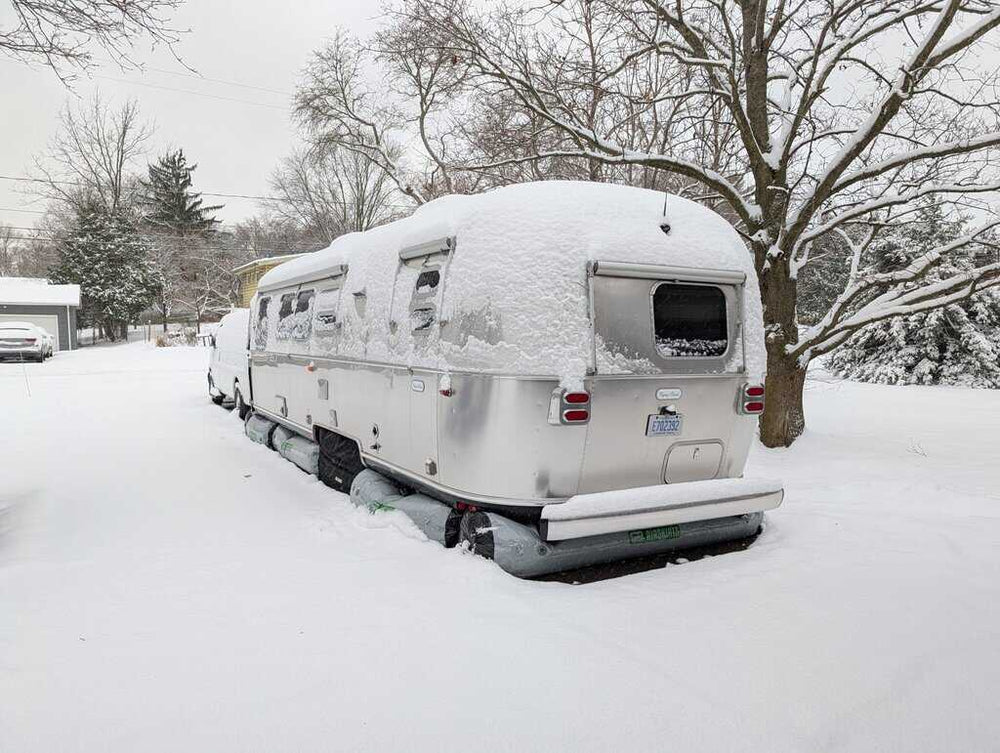 Airstream RV skirted in winter snow