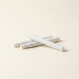 Three white primer pens for prepping the surface before placing studs